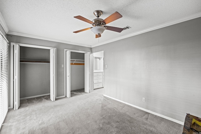 508 Green Mountain Cir Unit 80, Little Rock, AR 72211 - unfurnished bedroom with two closets, crown molding, carpet flooring, baseboards, and a ceiling fan