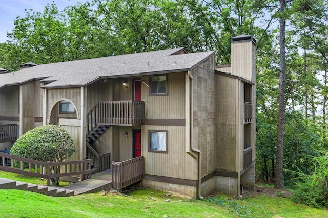 508 Green Mountain Cir Unit 80, Little Rock, AR 72211 - view of front facade featuring a shingled roof, a chimney, and stairway