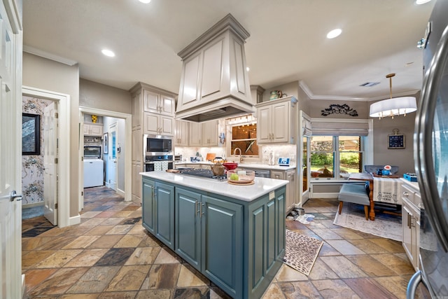 kitchen with stainless steel appliances, stone tile flooring, light countertops, ornamental molding, and baseboards