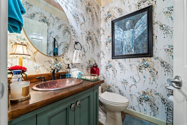 bathroom featuring wallpapered walls, vanity, and toilet