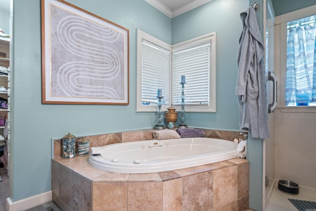 bathroom featuring a bath, ornamental molding, and healthy amount of natural light