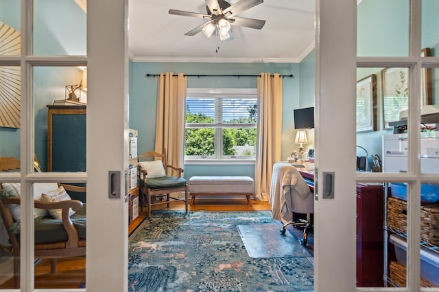 office featuring ornamental molding, a ceiling fan, and wood finished floors