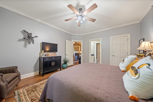 bedroom with wood finished floors, crown molding, ceiling fan, and baseboards
