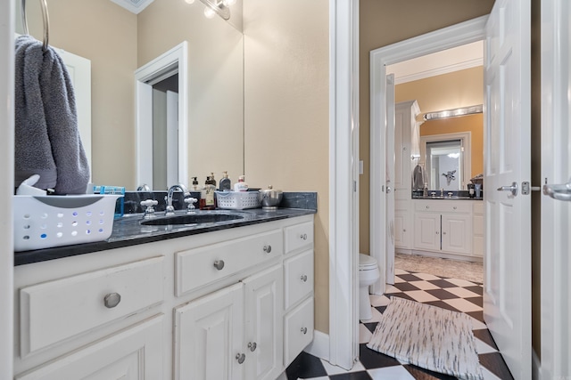 bathroom featuring tile patterned floors, vanity, and toilet