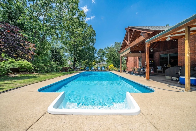 outdoor pool with a patio area