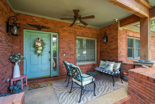 entrance to property featuring a ceiling fan, brick siding, a security system, and a porch