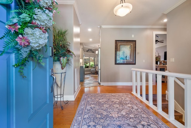entrance foyer featuring ornamental molding, light wood-style flooring, baseboards, a ceiling fan, and recessed lighting
