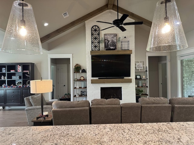 106 Harmony Village Dr, Haskell, AR 72015 - living room with wood finished floors, a ceiling fan, high vaulted ceiling, beam ceiling, and a brick fireplace