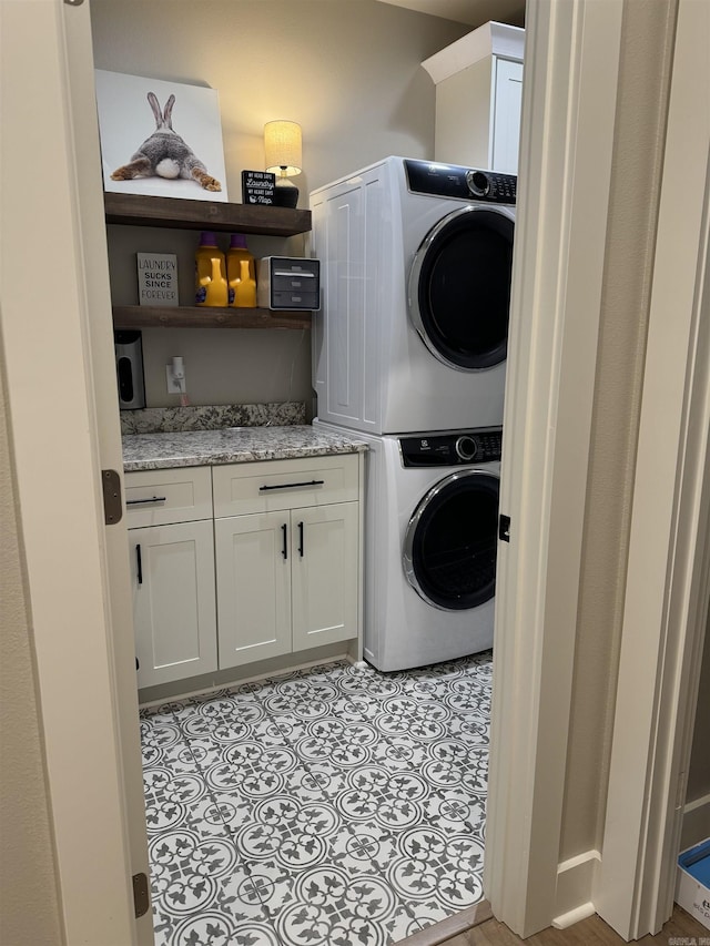 106 Harmony Village Dr, Haskell, AR 72015 - laundry area with stacked washer / dryer and cabinet space