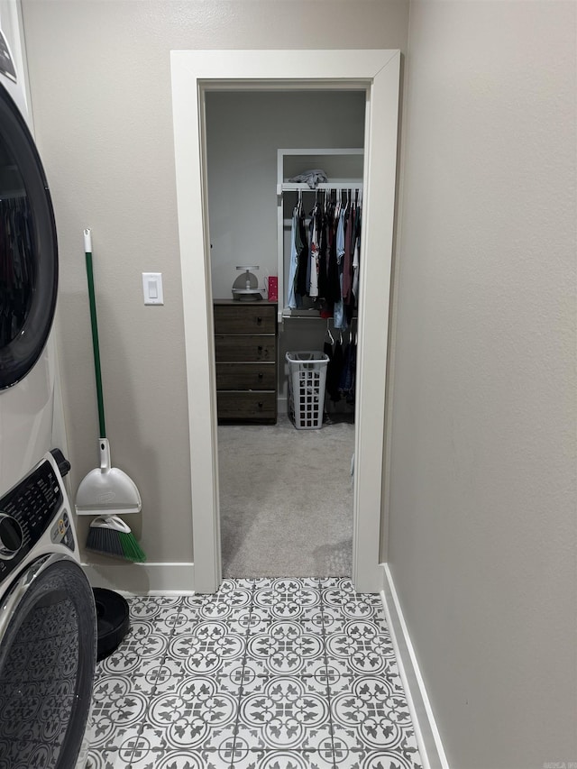 106 Harmony Village Dr, Haskell, AR 72015 - laundry room with stacked washer and clothes dryer and baseboards
