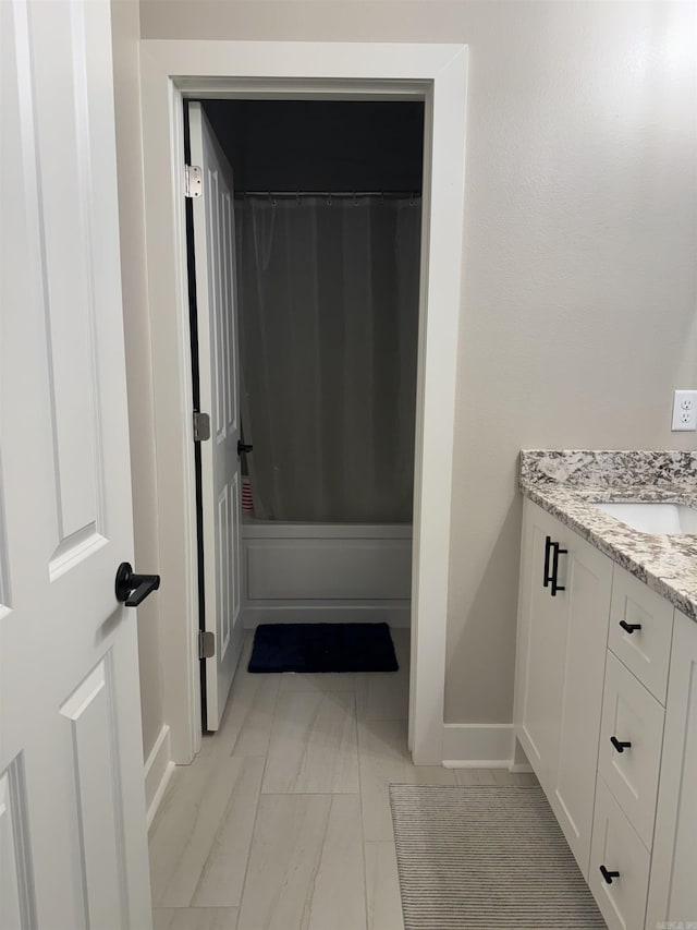 106 Harmony Village Dr, Haskell, AR 72015 - full bath featuring vanity, baseboards, marble look tiles, and shower / bath combination with curtain