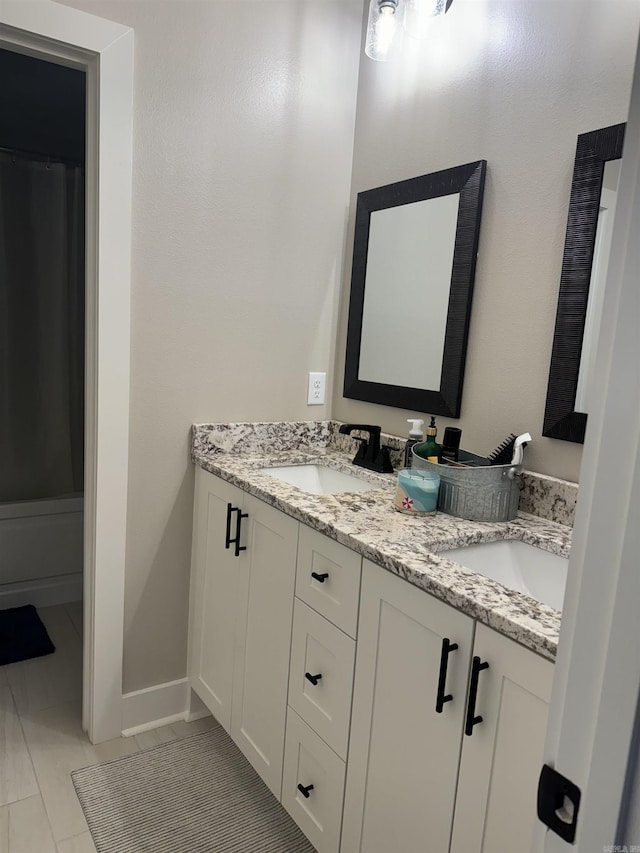 106 Harmony Village Dr, Haskell, AR 72015 - bathroom featuring double vanity and baseboards