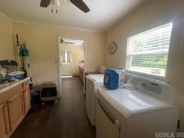 laundry room featuring washer and dryer, heating unit, ceiling fan, dark wood-style flooring, and crown molding