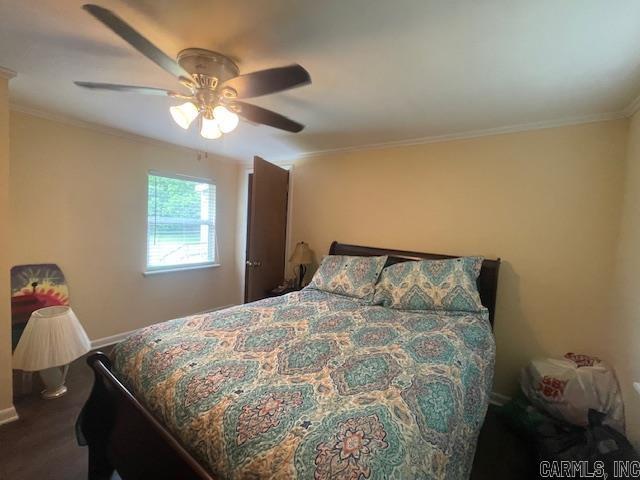 bedroom with baseboards, ornamental molding, and ceiling fan