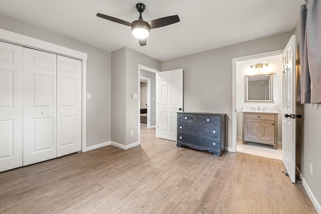 201 Sunset St, Hot Springs, AR 71913 - unfurnished bedroom featuring light wood-style floors, a closet, baseboards, ensuite bath, and a ceiling fan