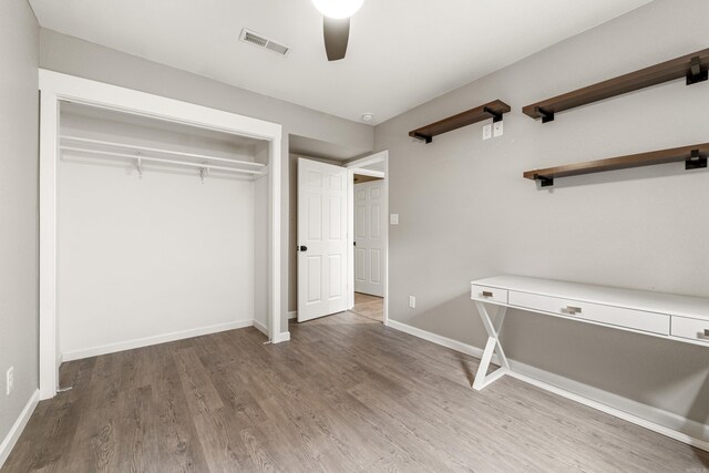 201 Sunset St, Hot Springs, AR 71913 - unfurnished bedroom with wood finished floors, a closet, baseboards, and a ceiling fan