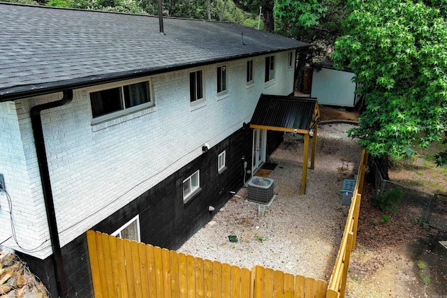 201 Sunset St, Hot Springs, AR 71913 - view of side of property with brick siding, roof with shingles, and central AC unit
