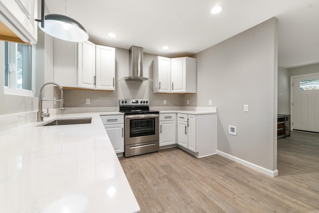 201 Sunset St, Hot Springs, AR 71913 - kitchen with electric stove, a sink, wall chimney range hood, light wood-type flooring, and recessed lighting