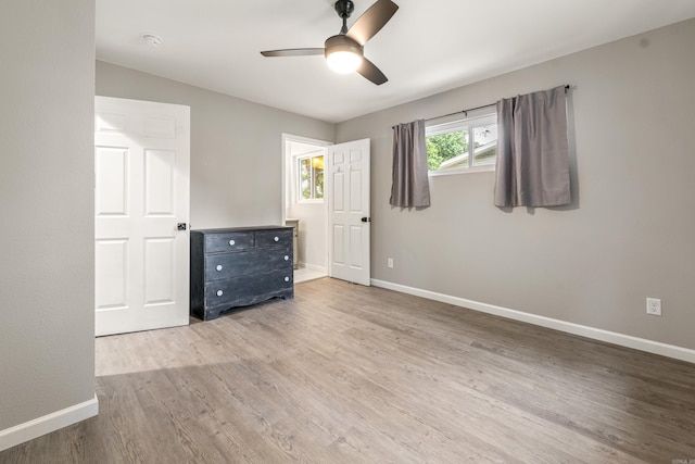 201 Sunset St, Hot Springs, AR 71913 - unfurnished bedroom featuring wood finished floors, baseboards, and ceiling fan
