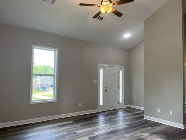 entryway featuring dark wood-type flooring, ceiling fan, baseboards, and vaulted ceiling