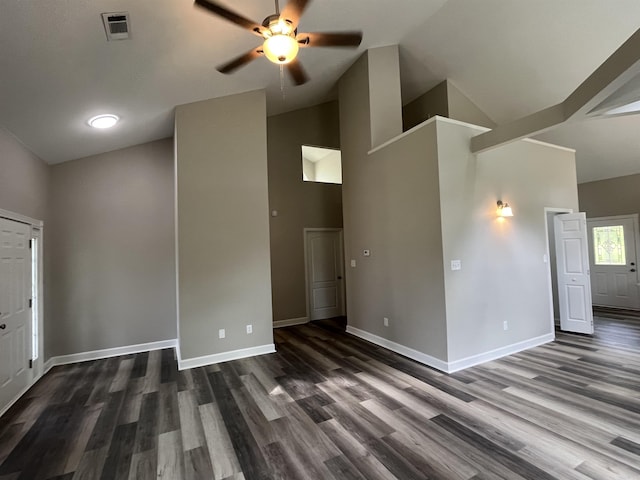 unfurnished living room with ceiling fan, dark wood-type flooring, baseboards, and high vaulted ceiling