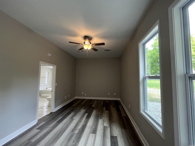 unfurnished room featuring wood finished floors, a ceiling fan, and baseboards