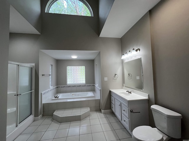 bathroom featuring vanity, a bath, toilet, tile patterned flooring, and a stall shower