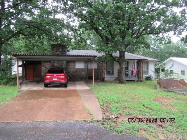 113 Dunn Hollow Dr, Fairfield Bay, AR 72088 - view of front of home featuring a chimney, stone siding, a front lawn, an attached carport, and driveway
