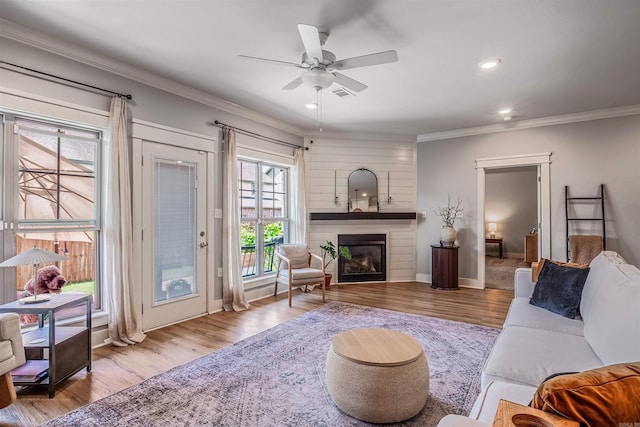 118 Lydia Dr, Maumelle, AR 72113 - living area featuring crown molding, a ceiling fan, a fireplace, wood finished floors, and recessed lighting