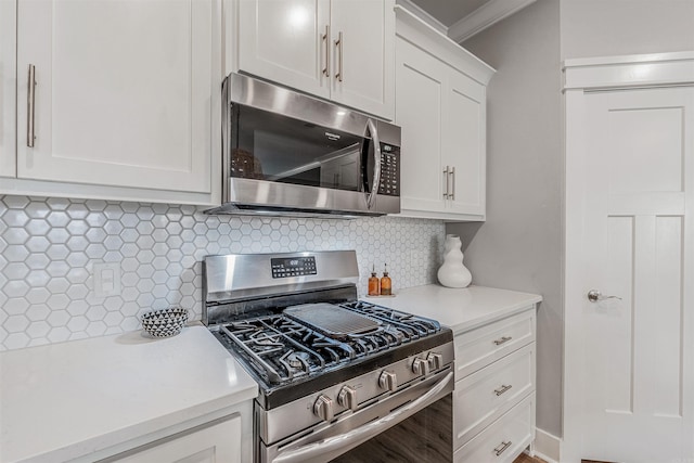 118 Lydia Dr, Maumelle, AR 72113 - kitchen with stainless steel appliances, light countertops, decorative backsplash, white cabinetry, and crown molding