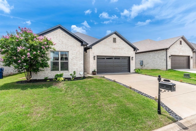 118 Lydia Dr, Maumelle, AR 72113 - french provincial home featuring a garage, driveway, brick siding, and a front yard