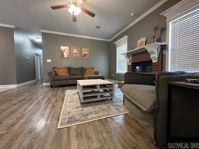 13815 Carrington Place Dr, Alexander, AR 72002 - living area with a ceiling fan, wood finished floors, ornamental molding, baseboards, and a brick fireplace