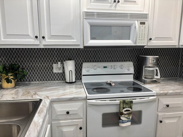 135 Hillview Dr Unit 19, Fairfield Bay, AR 72088 - kitchen featuring white appliances, white cabinets, and decorative backsplash