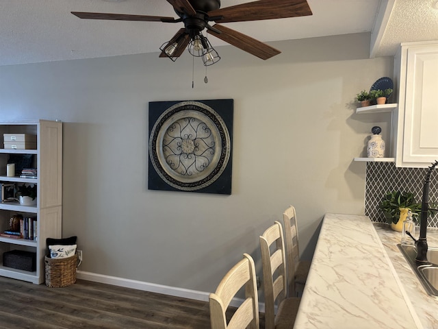 135 Hillview Dr Unit 19, Fairfield Bay, AR 72088 - dining space featuring a ceiling fan, dark wood-type flooring, and baseboards