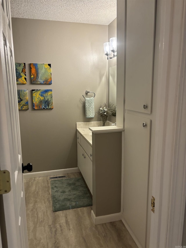 135 Hillview Dr Unit 19, Fairfield Bay, AR 72088 - bathroom featuring vanity, a textured ceiling, and baseboards