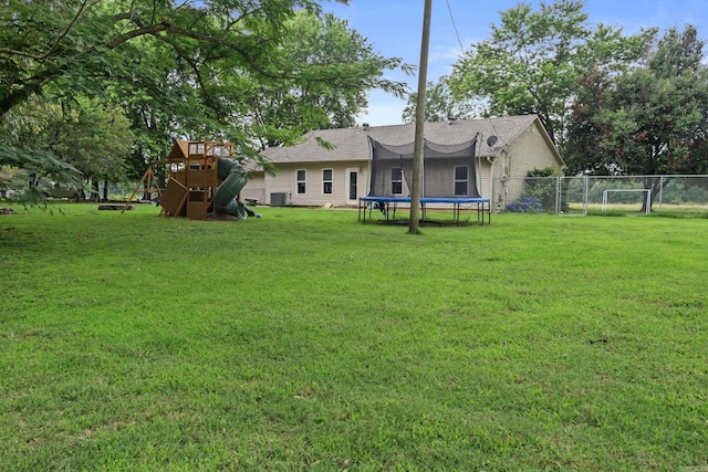 31 D Plummer Rd, Lonoke, AR 72023 - back of house featuring a trampoline, a playground, and a gate