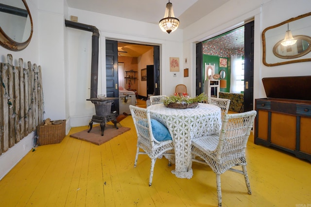 1107 Magnolia, Mena, AR 71953 - dining area with hardwood / wood-style floors and a wood stove