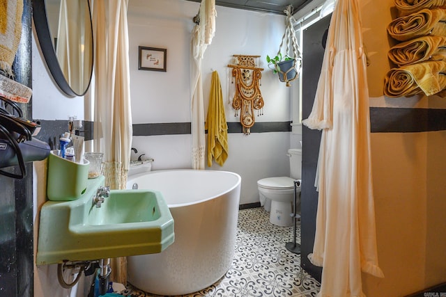 1107 Magnolia, Mena, AR 71953 - full bathroom featuring a freestanding tub and toilet