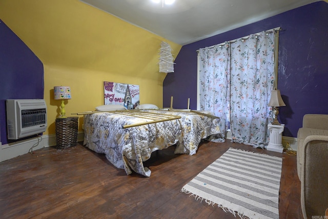 1107 Magnolia, Mena, AR 71953 - bedroom featuring heating unit, lofted ceiling, and wood finished floors