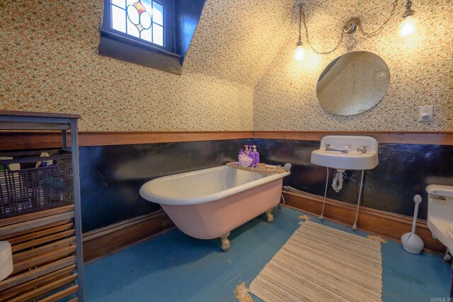 1107 Magnolia, Mena, AR 71953 - full bath featuring a freestanding tub, toilet, and wallpapered walls