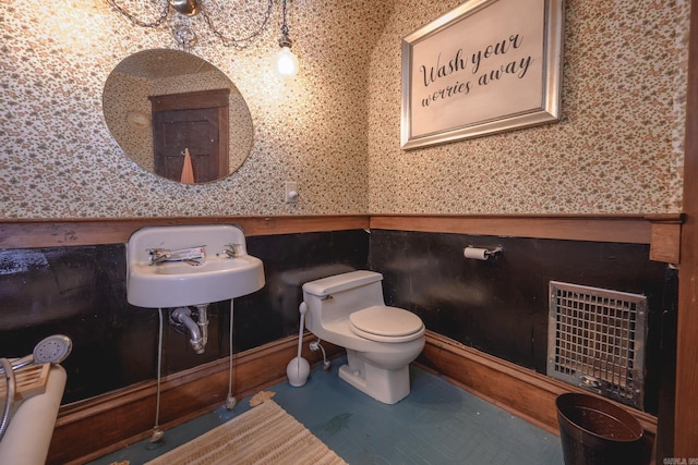 1107 Magnolia, Mena, AR 71953 - half bathroom with wainscoting, wallpapered walls, toilet, a sink, and heating unit