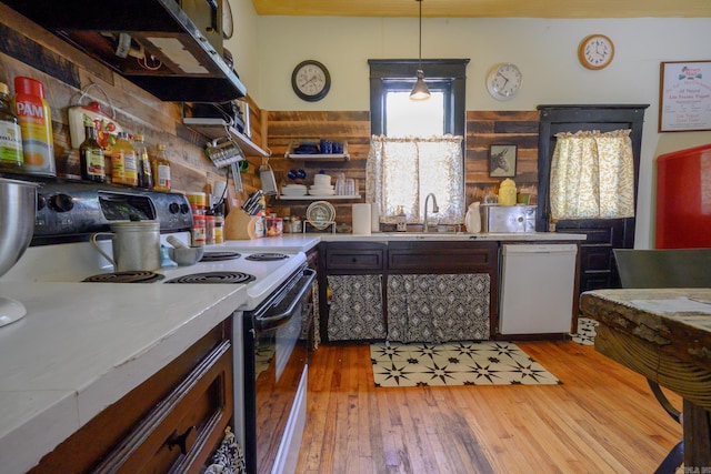 1107 Magnolia, Mena, AR 71953 - kitchen featuring white appliances, a sink, light wood-style flooring, ventilation hood, and light countertops
