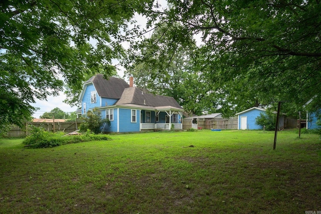 1107 Magnolia, Mena, AR 71953 - rear view of property featuring a chimney and covered porch