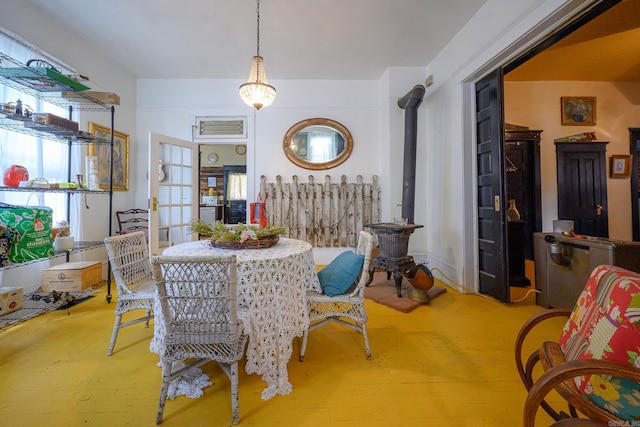 1107 Magnolia, Mena, AR 71953 - dining room with a wood stove and wood finished floors