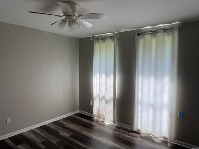 211 Turner St, Mena, AR 71953 - unfurnished room with dark wood finished floors, ceiling fan, and baseboards