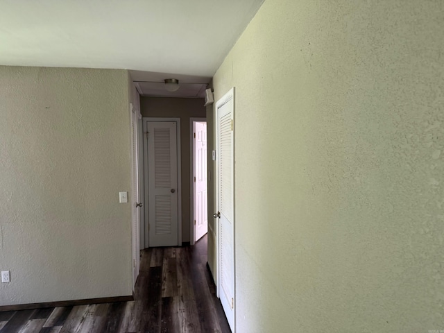 211 Turner St, Mena, AR 71953 - corridor with dark wood finished floors and a textured wall