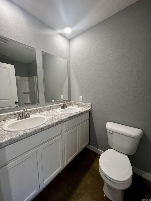 233 Iris, Benton, AR 72015 - bathroom featuring double vanity, toilet, and baseboards
