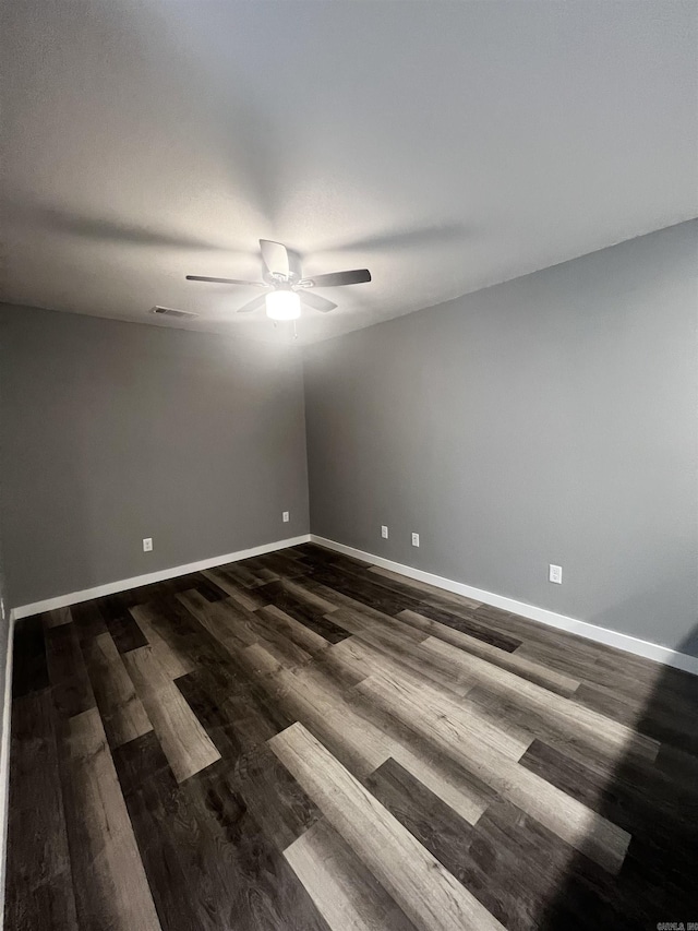 233 Iris, Benton, AR 72015 - unfurnished room with ceiling fan, dark wood finished floors, and baseboards