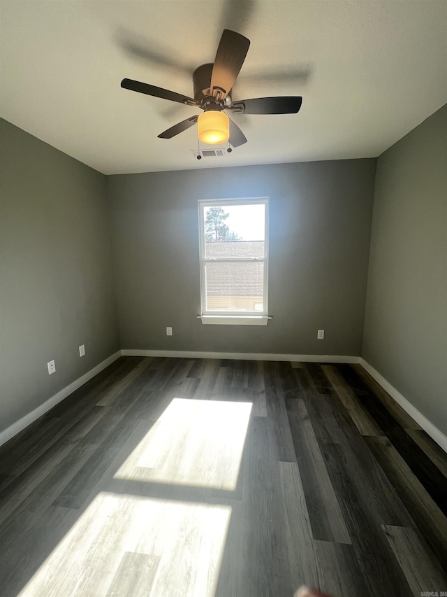 233 Iris, Benton, AR 72015 - unfurnished room with baseboards, a ceiling fan, and dark wood finished floors