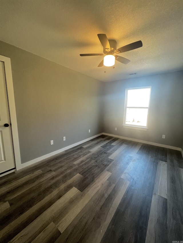 233 Iris, Benton, AR 72015 - empty room with baseboards, ceiling fan, dark wood-type flooring, and a textured ceiling